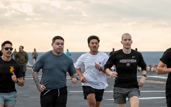 Sailors and Marines Run on the Flight Deck Aboard USS Tripoli