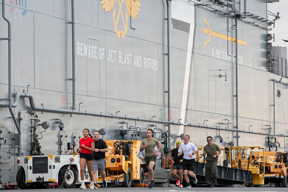 Sailors and Marines Run on the Flight Deck Aboard USS Tripoli