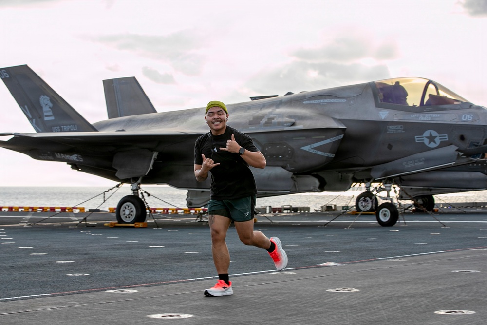 Sailors and Marines Run on the Flight Deck Aboard USS Tripoli