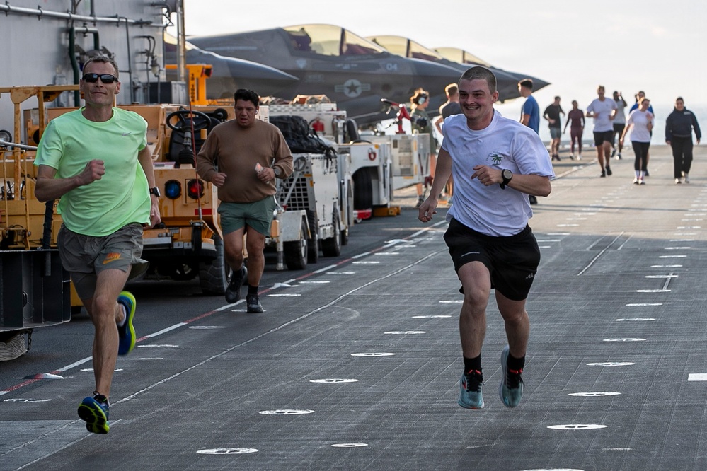 Sailors and Marines Run on the Flight Deck Aboard USS Tripoli