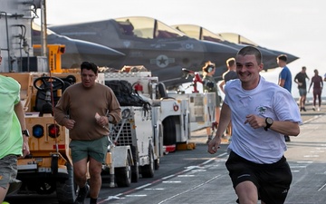 Sailors and Marines Run on the Flight Deck Aboard USS Tripoli