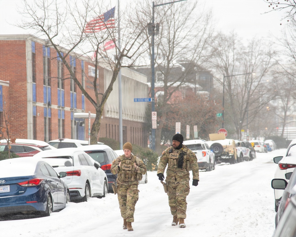 Service members conduct presence patrols during the winter