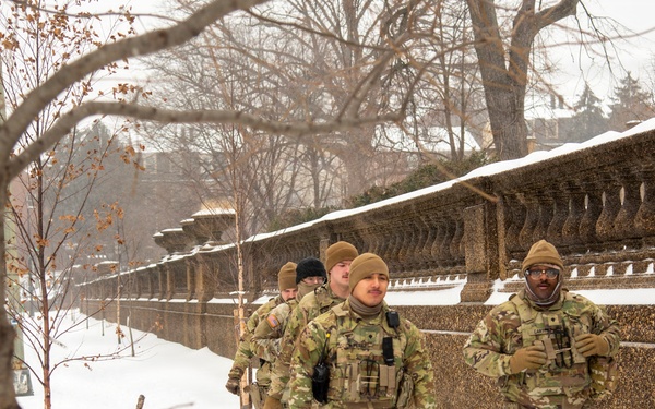 Service members conduct presence patrols during the winter