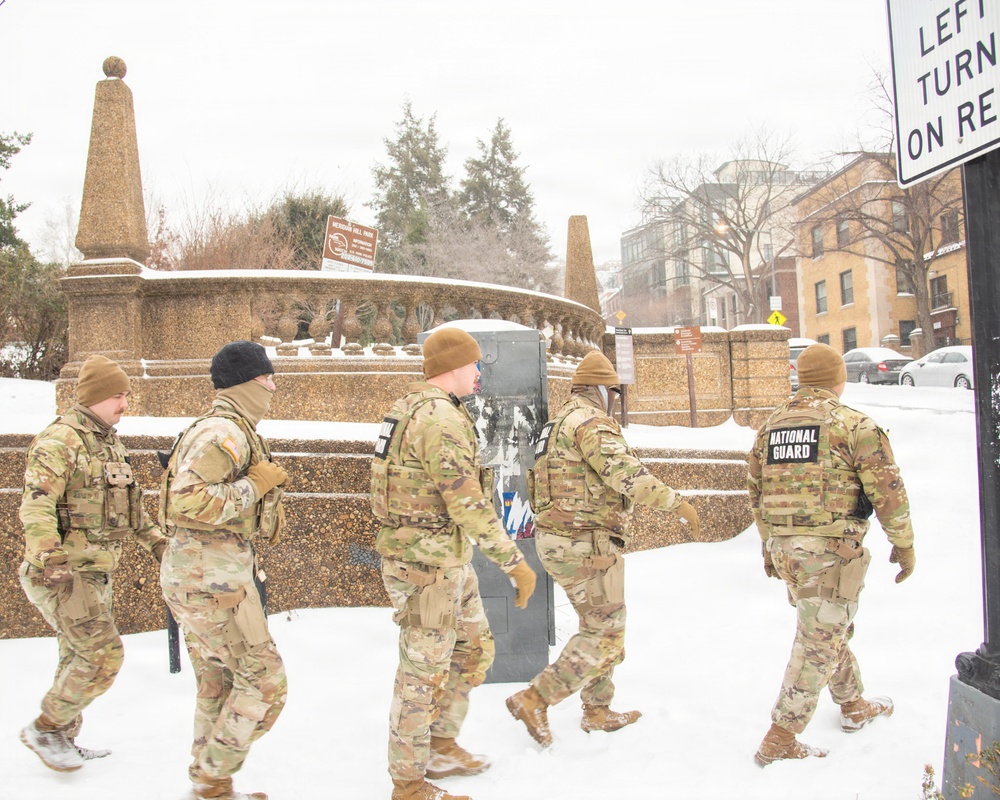 Service members conduct presence patrols during the winter