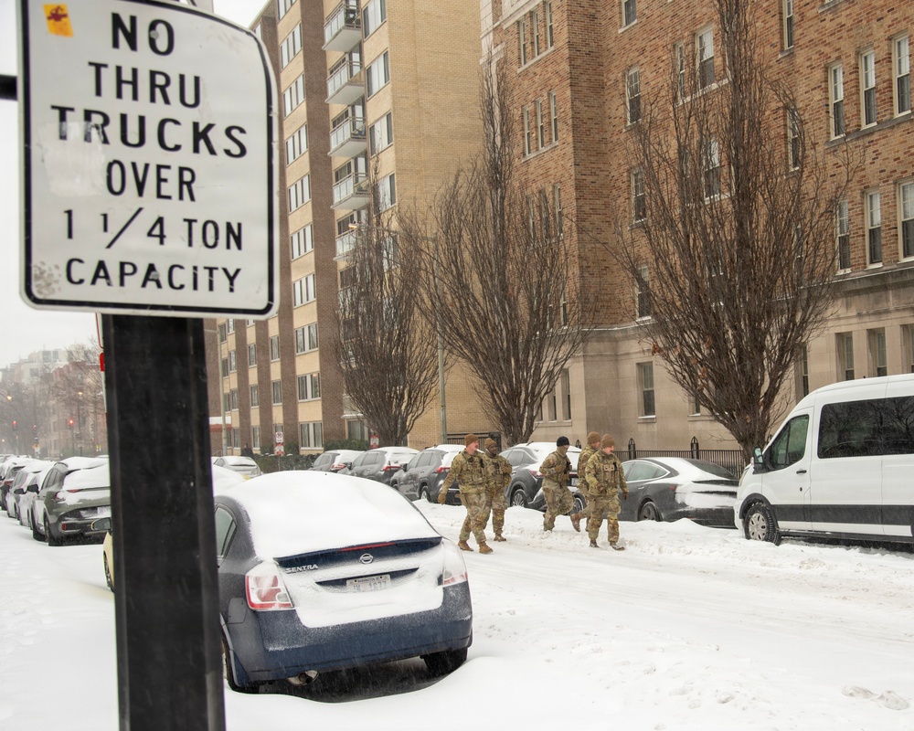 Service members conduct presence patrols during the winter