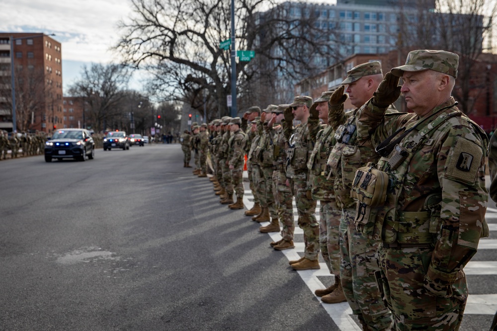 Mississippi National Guard service members salute a fallen officer during a dignified escort in Washington, D.C.