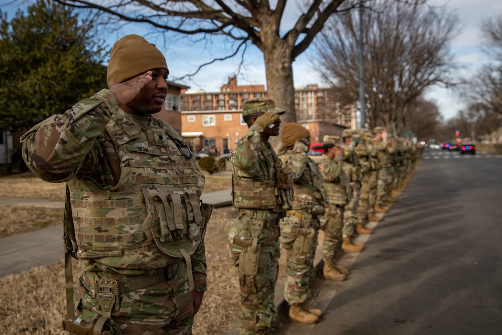 Mississippi National Guard service members salute a fallen officer during a dignified escort in Washington, D.C.
