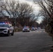 National Guard service members salute a fallen officer during a dignified escort in Washington, D.C.