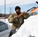 Maryland Army National Guard Soldier Cleans Snow off a Car During Operation Blur