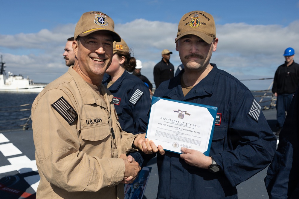 Rear Adm. Forrest Young, Commander, Carrier Strike Group (CSG) 8, Presents Awards to USS Jason Dunham (DDG 109)
