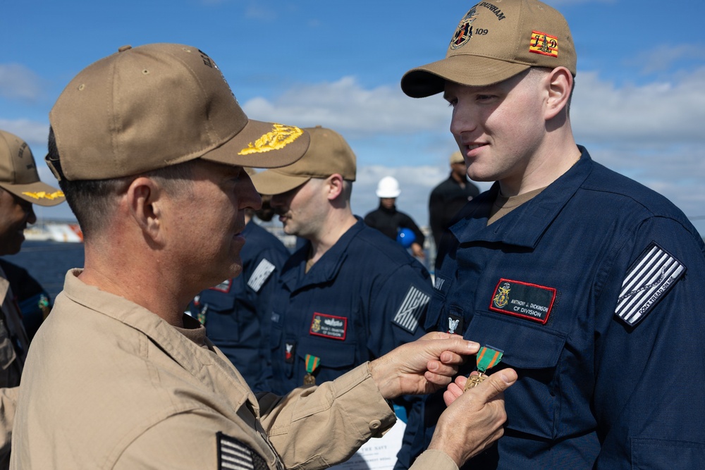 Rear Adm. Forrest Young, Commander, Carrier Strike Group (CSG) 8, Presents Awards to USS Jason Dunham (DDG 109)