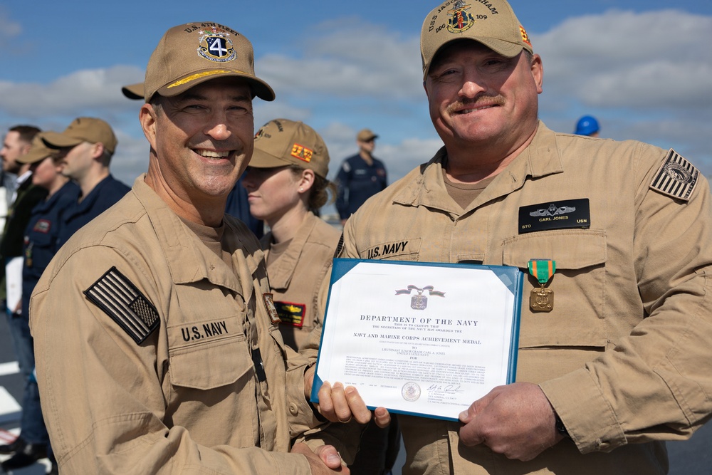 Rear Adm. Forrest Young, Commander, Carrier Strike Group (CSG) 8, Presents Awards to USS Jason Dunham (DDG 109)