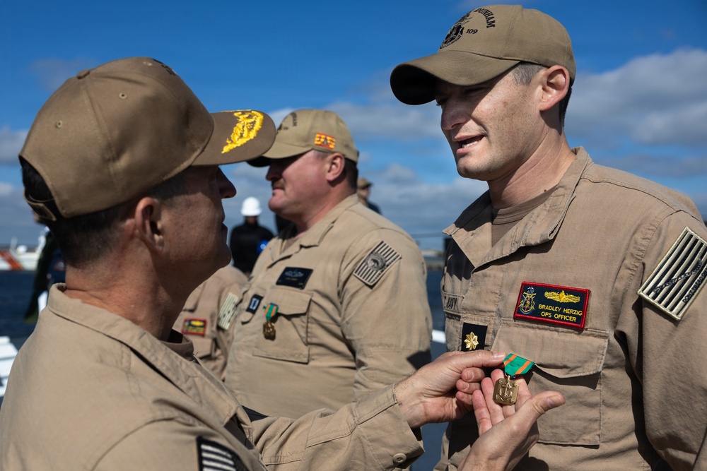 Rear Adm. Forrest Young, Commander, Carrier Strike Group (CSG) 8, Presents Awards to USS Jason Dunham (DDG 109)
