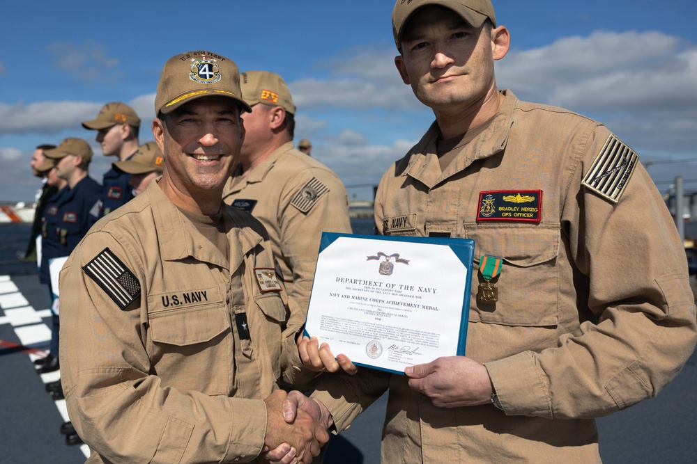 Rear Adm. Forrest Young, Commander, Carrier Strike Group (CSG) 8, Presents Awards to USS Jason Dunham (DDG 109)