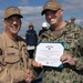 Rear Adm. Forrest Young, Commander, Carrier Strike Group (CSG) 8, Presents Awards to USS Jason Dunham (DDG 109)