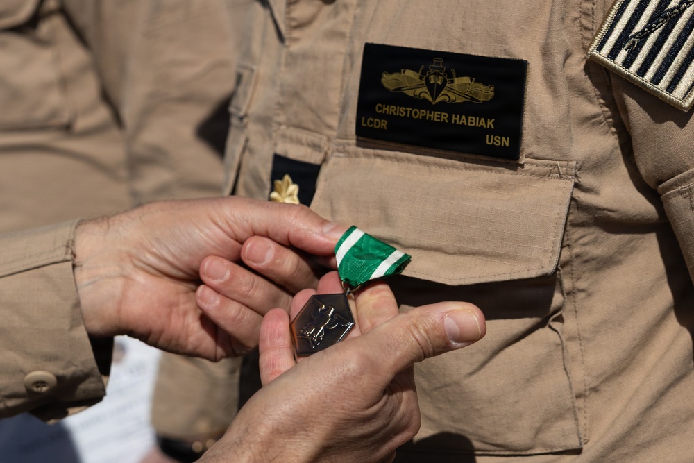 Rear Adm. Forrest Young, Commander, Carrier Strike Group (CSG) 8, Presents Awards to USS Jason Dunham (DDG 109)