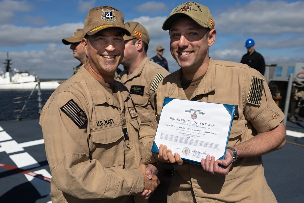 Rear Adm. Forrest Young, Commander, Carrier Strike Group (CSG) 8, Presents Awards to USS Jason Dunham (DDG 109)
