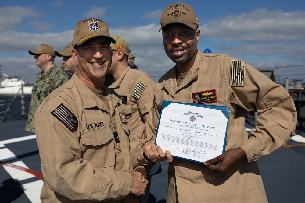 Rear Adm. Forrest Young, Commander, Carrier Strike Group (CSG) 8, Presents Awards to USS Jason Dunham (DDG 109)
