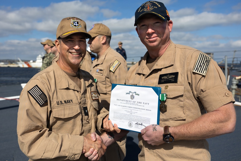 Rear Adm. Forrest Young, Commander, Carrier Strike Group (CSG) 8, Presents Awards to USS Jason Dunham (DDG 109)
