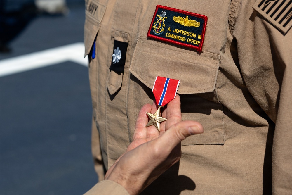 Rear Adm. Forrest Young, Commander, Carrier Strike Group (CSG) 8, Presents Awards to USS Jason Dunham (DDG 109)