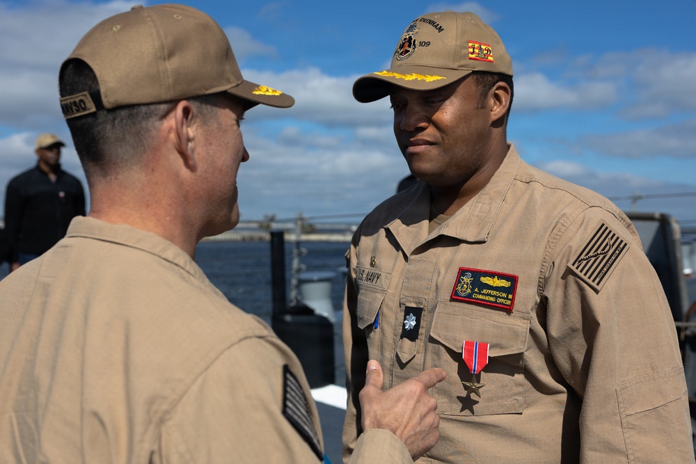 Rear Adm. Forrest Young, Commander, Carrier Strike Group (CSG) 8, Presents Awards to USS Jason Dunham (DDG 109)