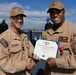 Rear Adm. Forrest Young, Commander, Carrier Strike Group (CSG) 8, Presents Awards to USS Jason Dunham (DDG 109)