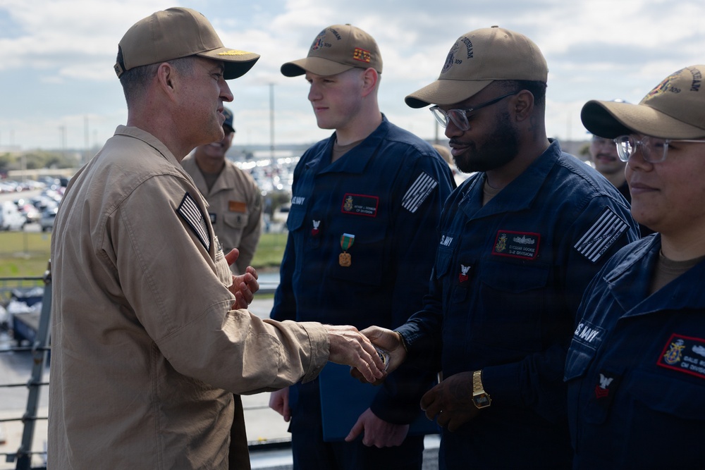 Rear Adm. Forrest Young, Commander, Carrier Strike Group (CSG) 8, Presents Awards to USS Jason Dunham (DDG 109)