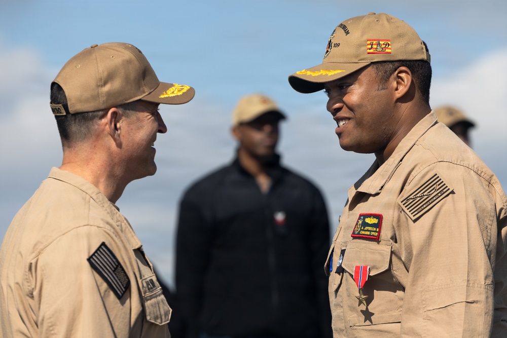Rear Adm. Forrest Young, Commander, Carrier Strike Group (CSG) 8, Presents Awards to USS Jason Dunham (DDG 109)