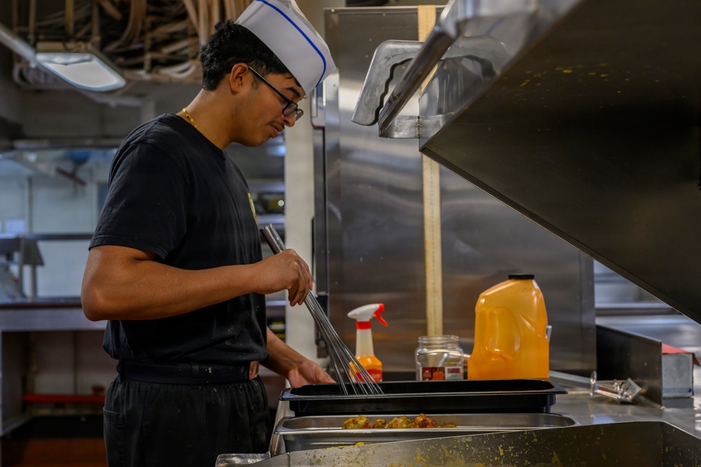 USS Theodore Roosevelt Sailor Prepares a Meal