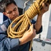 USS Mitscher (DDG 57) Sailor repairs rope on weather deck