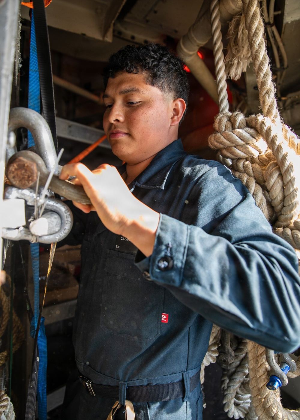 USS Mitscher (DDG 57) Sailor stows gear in boatswain's locker
