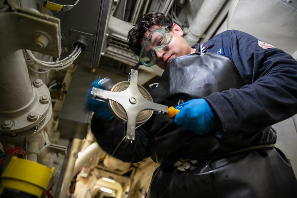USS Mitscher (DDG 57) Sailor takes fuel sample