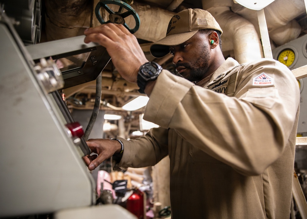 USS Mitscher (DDG 57) Chief inspects air pressure in engine room