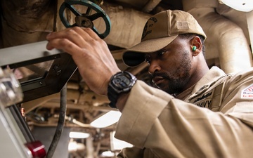 USS Mitscher (DDG 57) Chief inspects air pressure in engine room