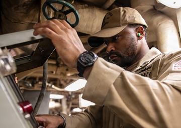 USS Mitscher (DDG 57) Chief inspects air pressure in engine room