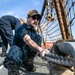 USS Mitscher (DDG 57) Sailor secures mooring line during sea and anchor