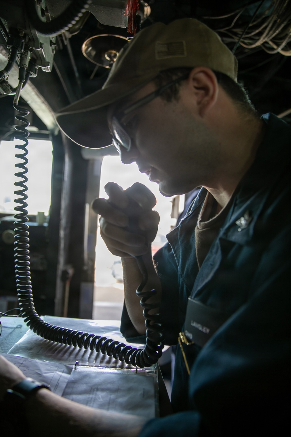 USS Mitscher (DDG 57) Sailor speaks on 1MC in ship bridge