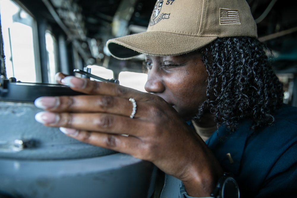 USS Mitscher (DDG 57) junior officer looks through navigational alidade in bridge