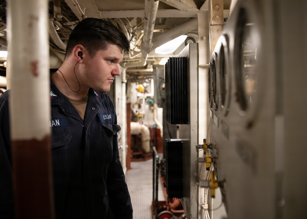 USS Mitscher (DDG 57) Sailor takes readings in engine room