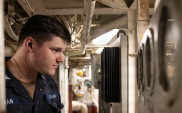 USS Mitscher (DDG 57) Sailor takes readings in engine room