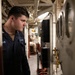 USS Mitscher (DDG 57) Sailor takes readings in engine room