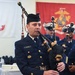 Coastguardsman Plays Bagpipes at 46th Coast Guard Cutter Blackthorn Memorial