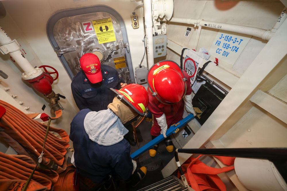 Sailors aboard the USS John Finn conduct a damage control drill in the South China Sea