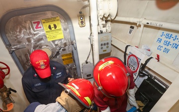 Sailors aboard the USS John Finn conduct a damage control drill in the South China Sea