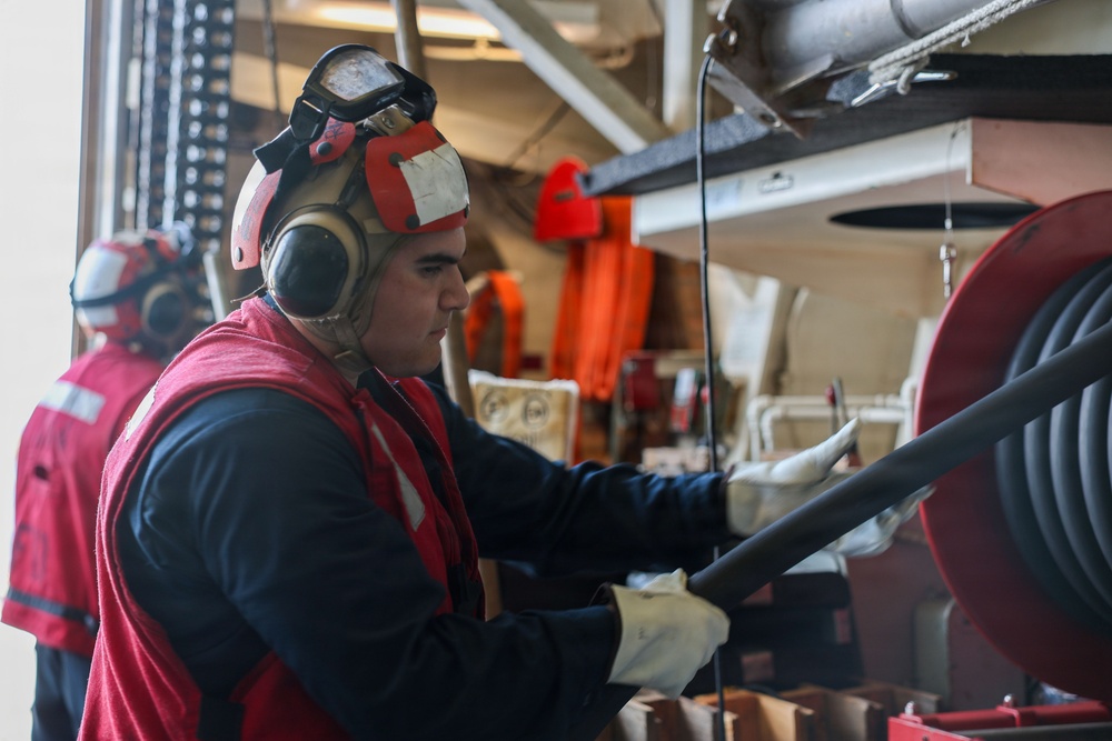 Sailors aboard the USS John Finn conduct a crash and salvage drill in the South China Sea