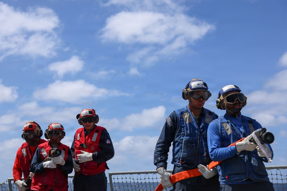 Sailors aboard the USS John Finn conduct a crash and salvage drill in the South China Sea
