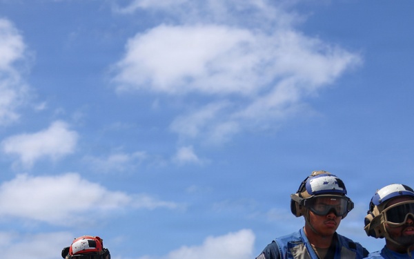 Sailors aboard the USS John Finn conduct a crash and salvage drill in the South China Sea