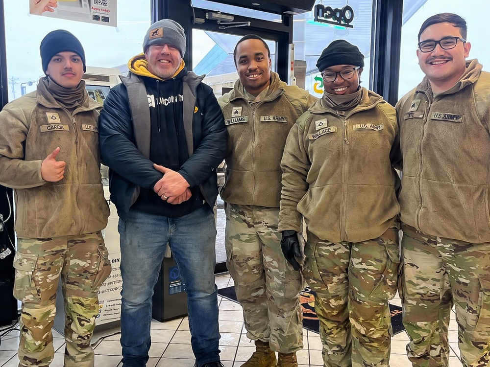 228th Theater Tactical Signal Brigade vehicle-recovery team assists a stranded vehicle during Winter Storm Gianna