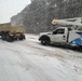 228th Theater Tactical Signal Brigade vehicle-recovery team assists a stranded vehicle during Winter Storm Gianna