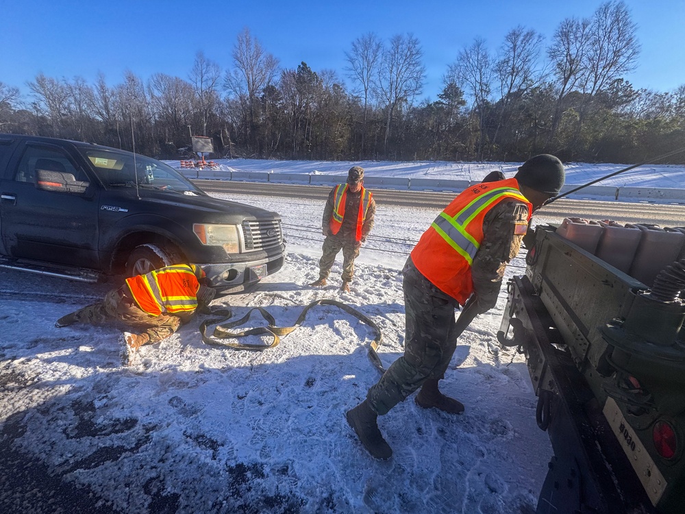 678th Air Defense Artillery Brigade vehicle-recovery team assist a stranded vehicle during Winter Storm Gianna&amp;#xA;